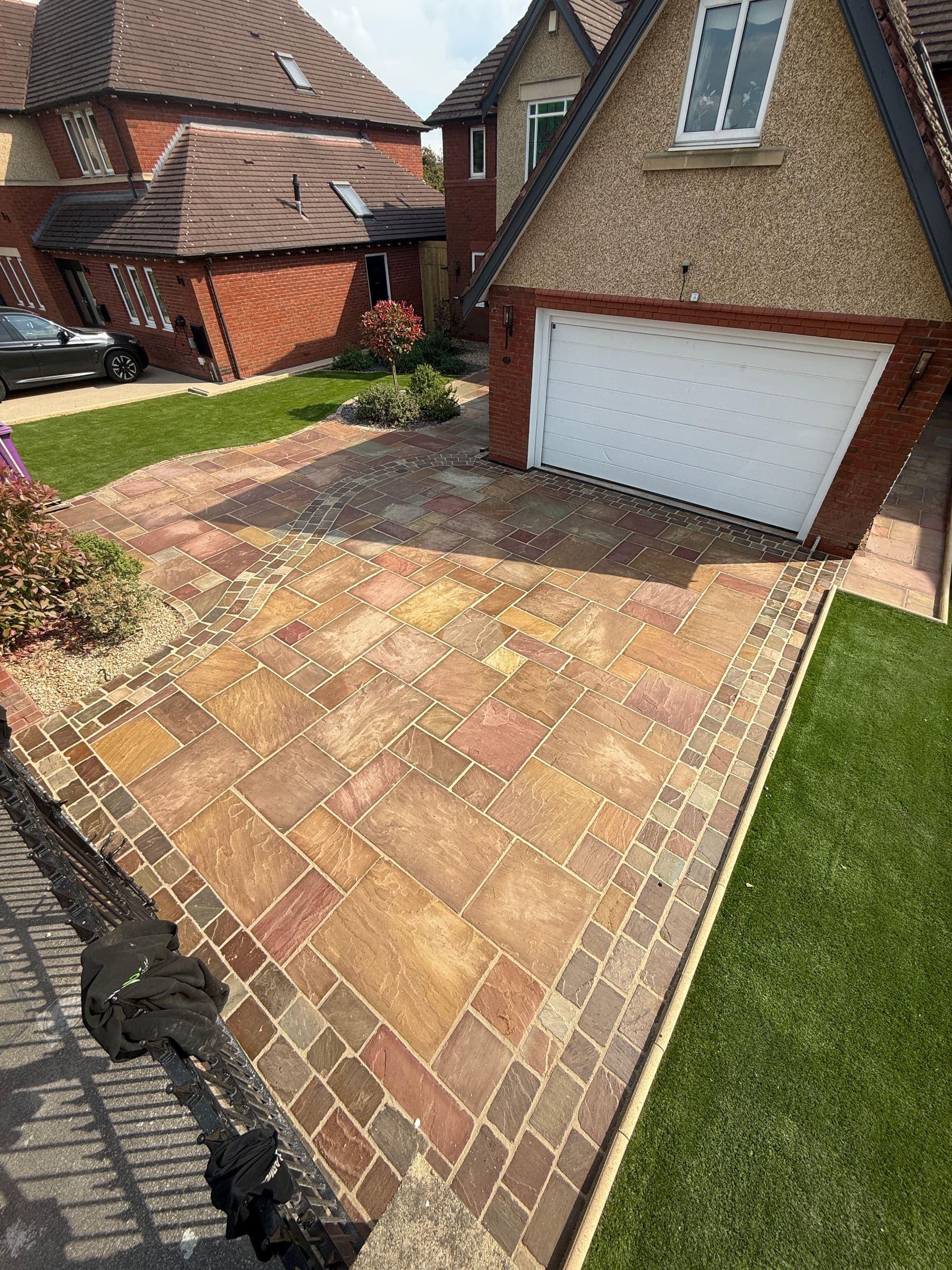 Indian sandstone patio next to a level lawn in a Liverpool garden