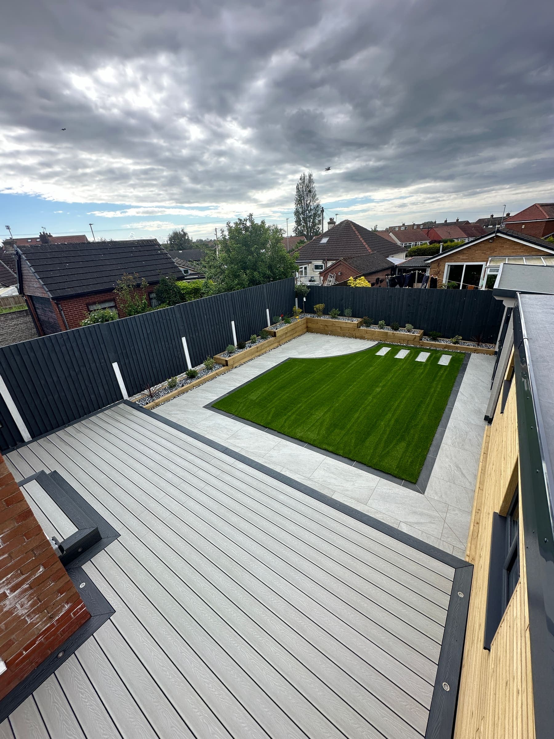 Artificial grass lawn beside composite decking in a Liverpool garden