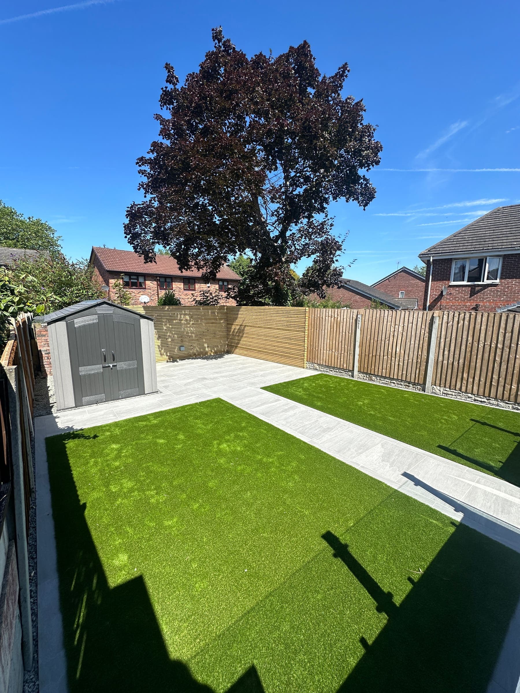 Artificial grass lawn with realistic synthetic turf and neat edging in a Liverpool garden