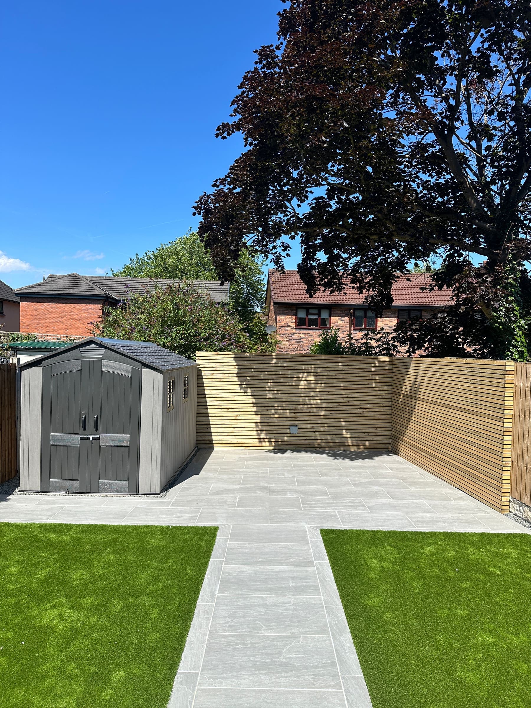 Artificial grass and synthetic turf beside garden fence panels in Liverpool