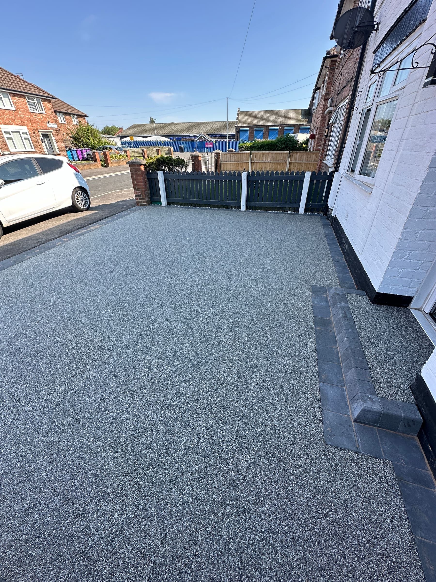 Grey resin driveway with drainage and edging at a Liverpool property
