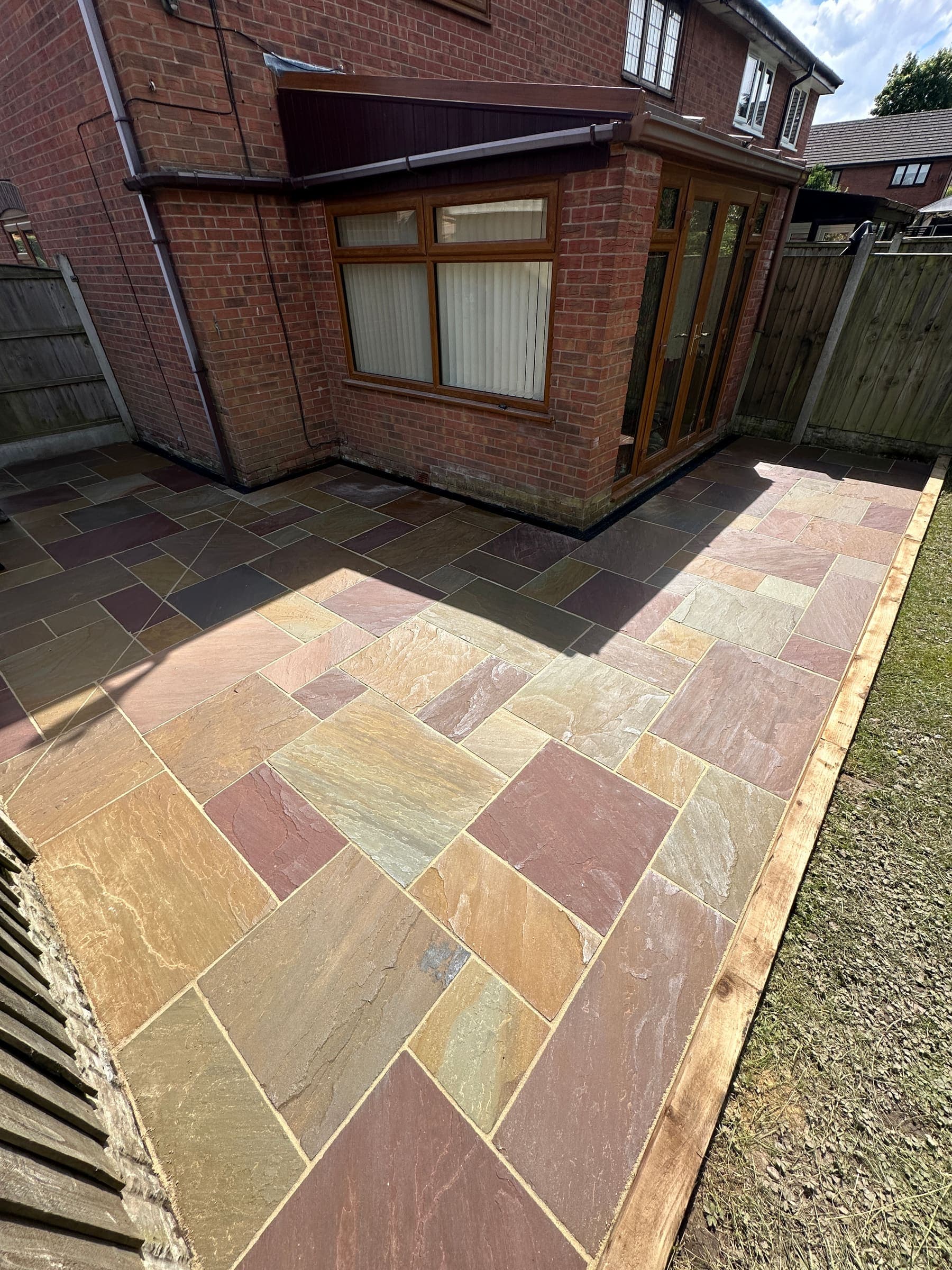 Indian sandstone patio against a brick Liverpool property
