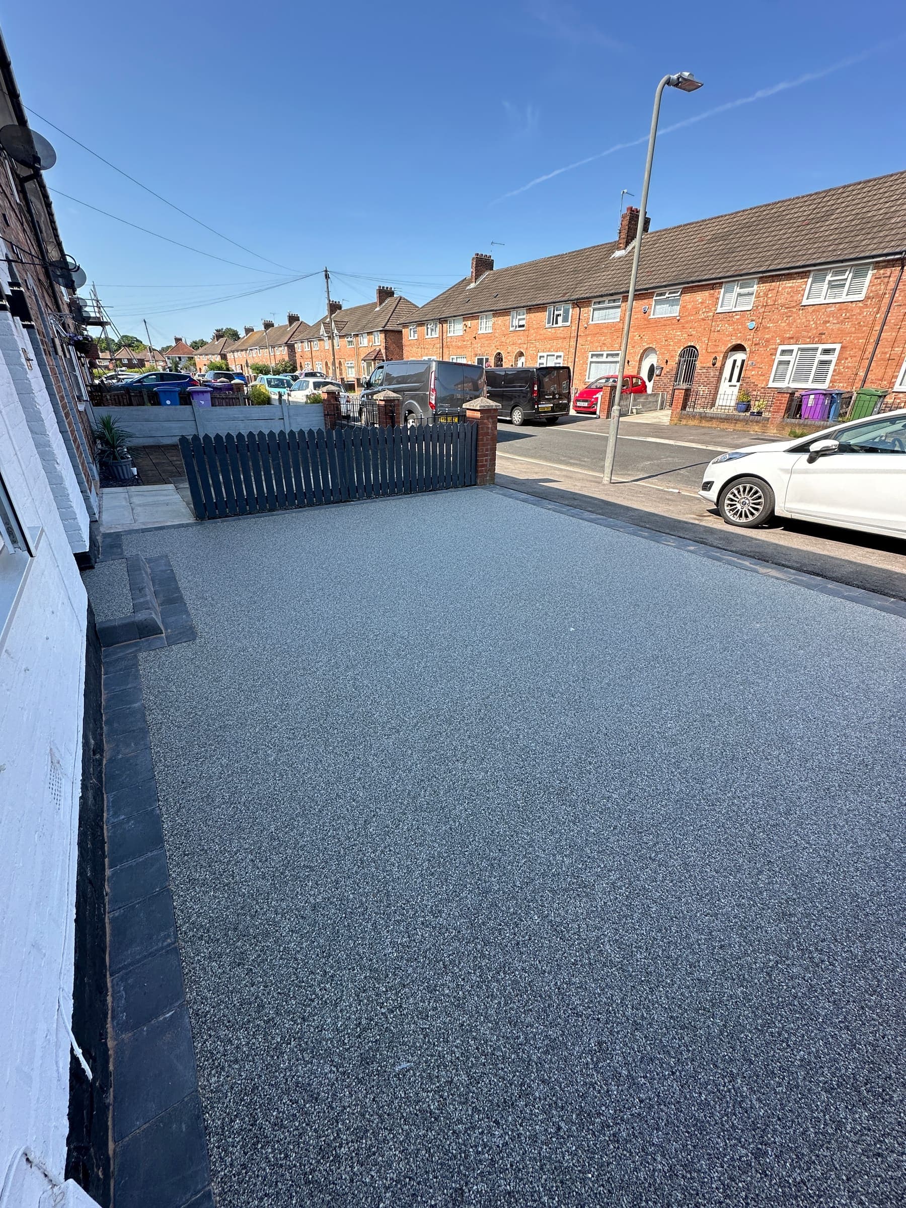 Large resin bound driveway with a parking area and gated entrance in Liverpool