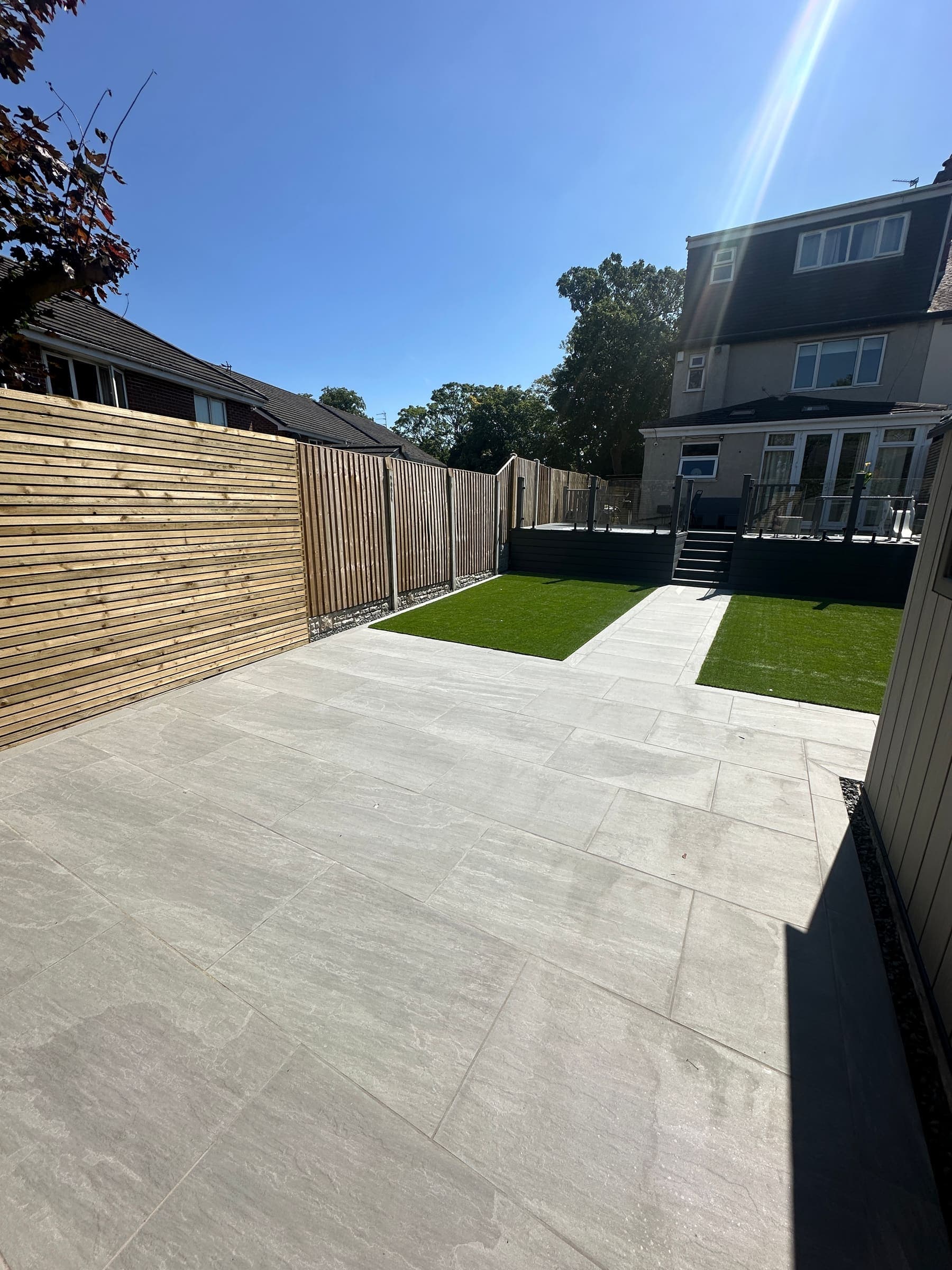 Low-maintenance Liverpool garden with a porcelain patio, artificial turf and timber fencing