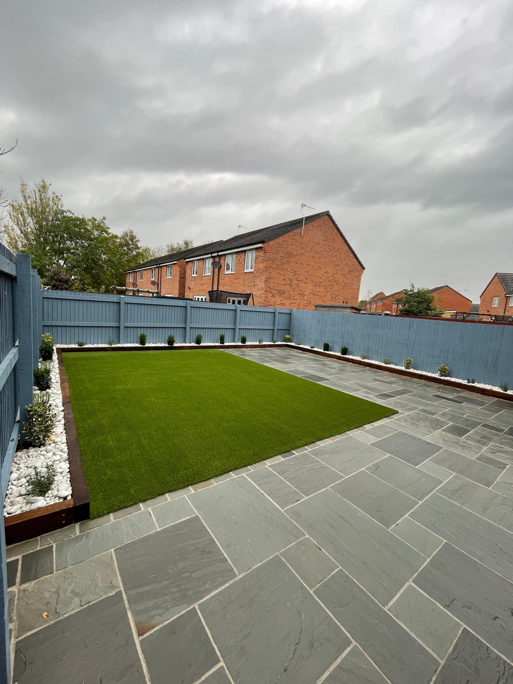 Low-maintenance Liverpool garden patio with porcelain paving and artificial turf