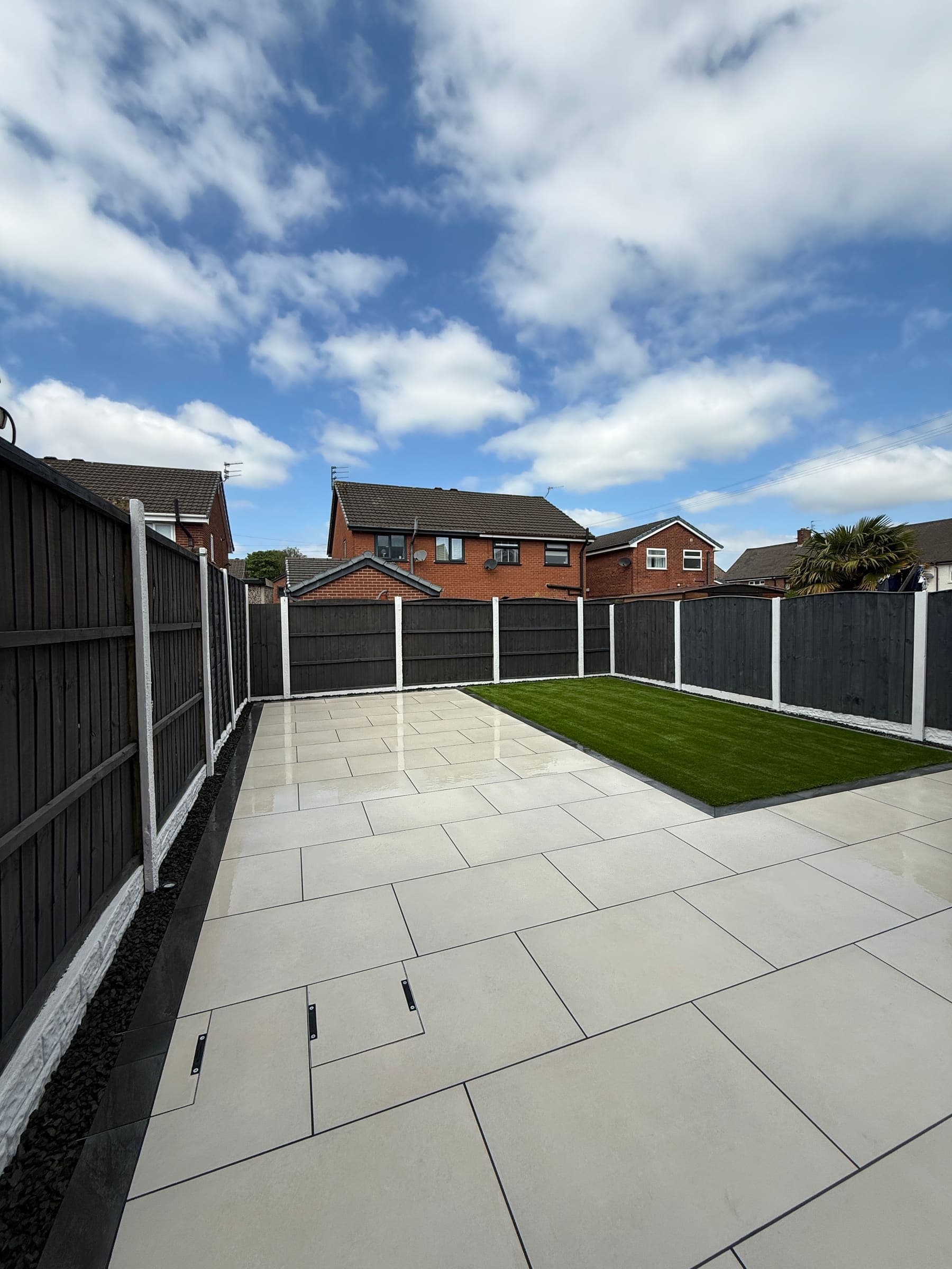 Porcelain patio with garden fence panels and artificial grass in Liverpool