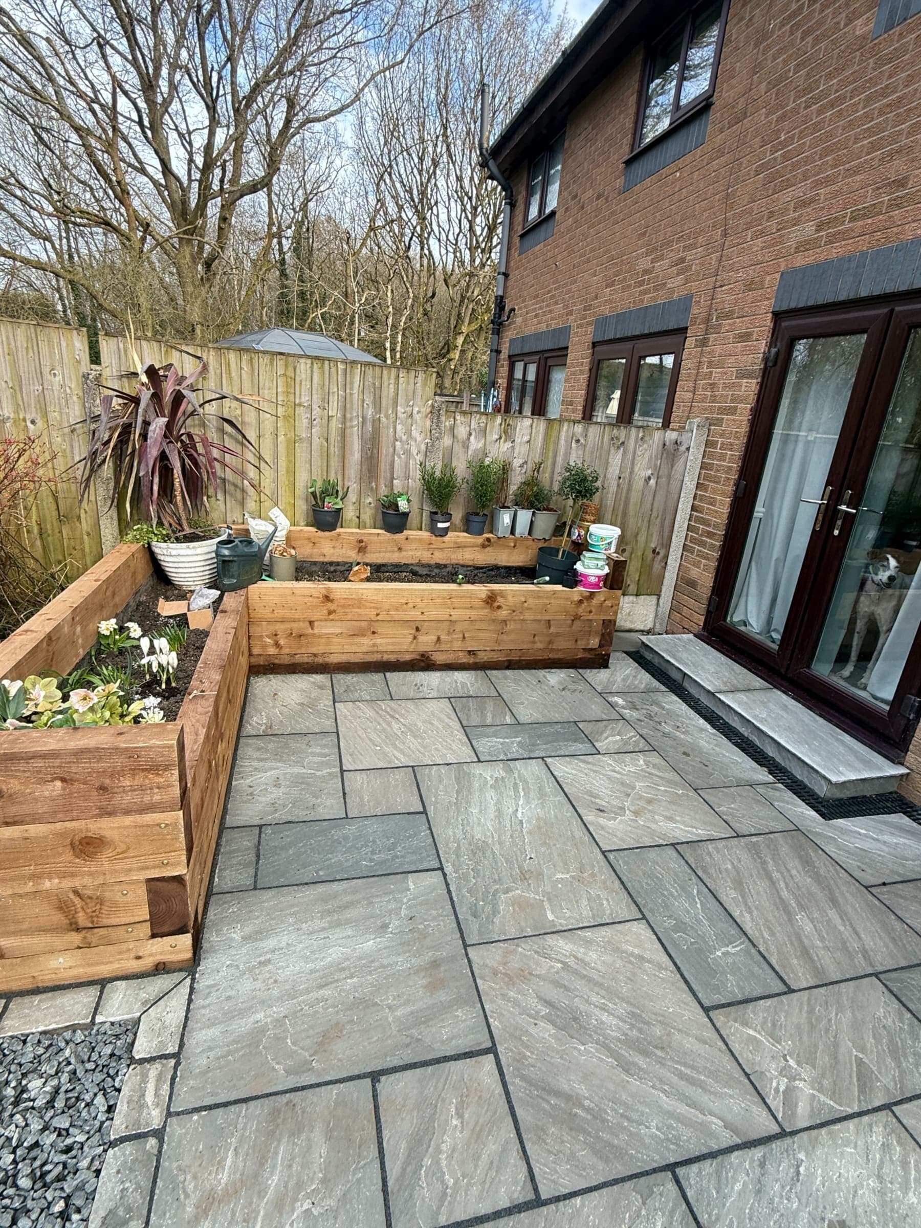 Landscaped Liverpool garden patio with porcelain paving and raised wooden planters