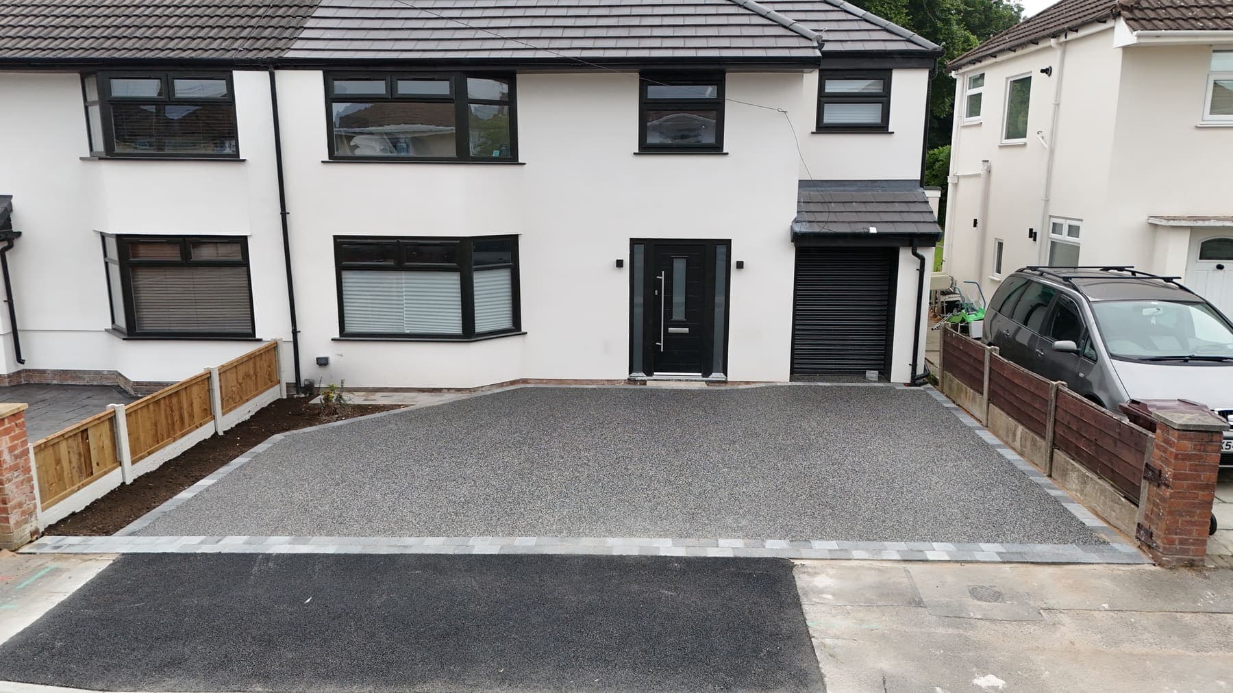 Wide resin driveway with a parking bay at a Liverpool semi detached house